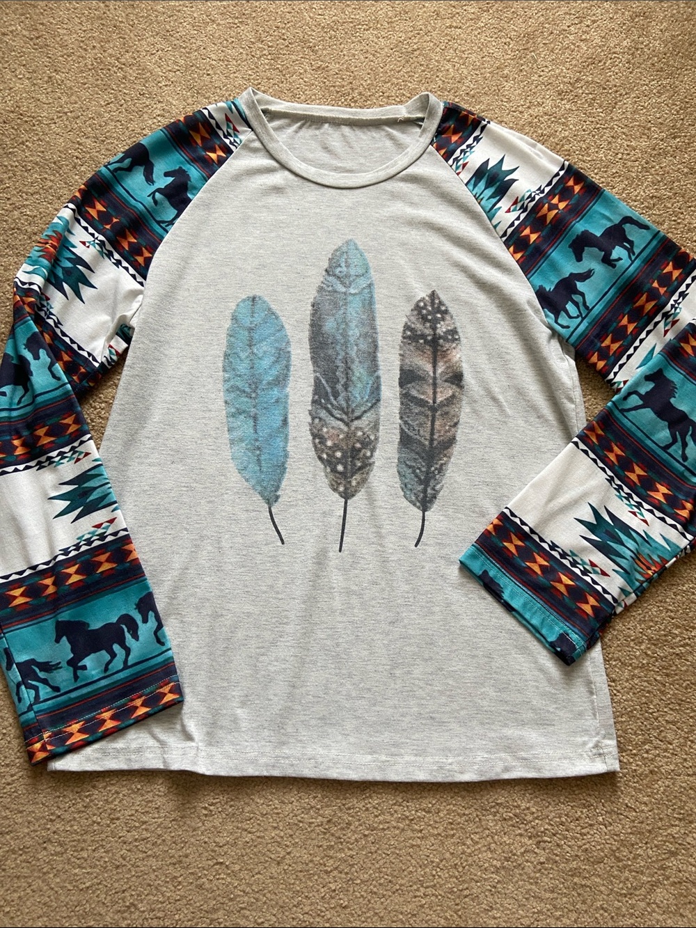 Junior’s light Grey Top with Teal Feather Print and Aztec Sleeve Pattern